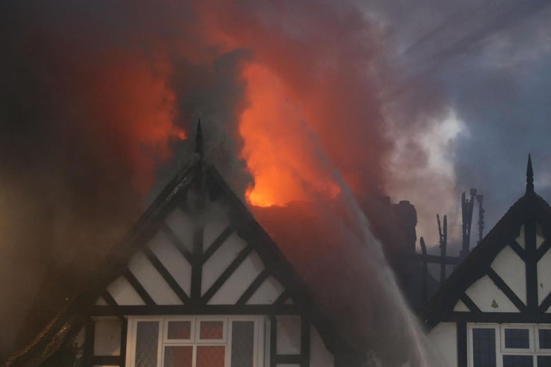 The fire ripped through the roof and destroyed eight flats and five shops