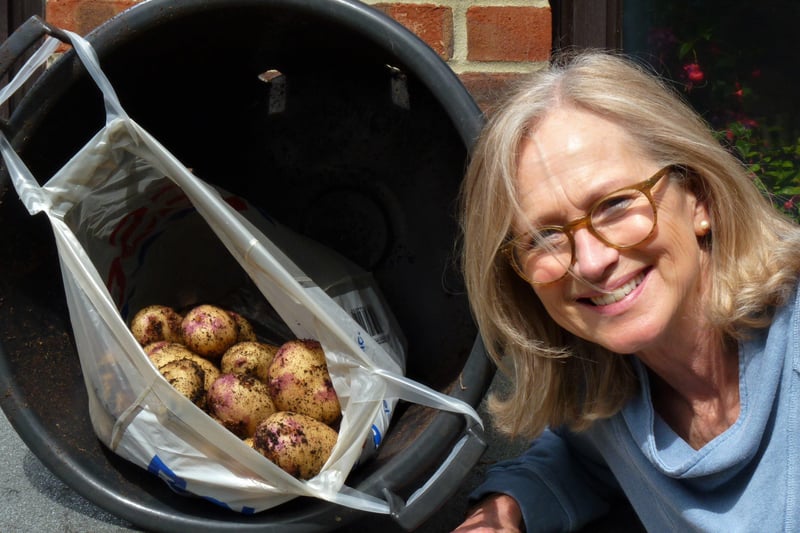 Judy Seers with the winning potatoes grown in a bucket