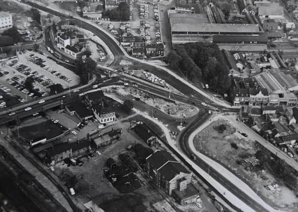 This is a great aerial shot of the city centre  which is now often referred to as Queensgate roundabout. You can see the top of Cowgate, the old Perkins factory and Crescent Bridge. Work is underway on Bourges Boulevard.