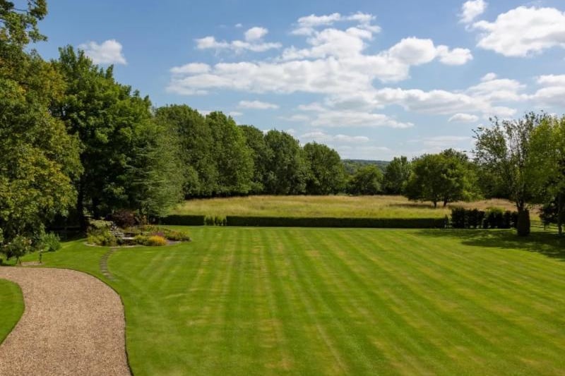 The vast landscaped and lawned gardens that surround the home.
