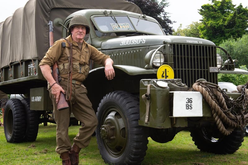 Pictured dressed as an  American 2nd Infantry soldier in front of his 1942 Chevrolet G506 is Martin Sharrett