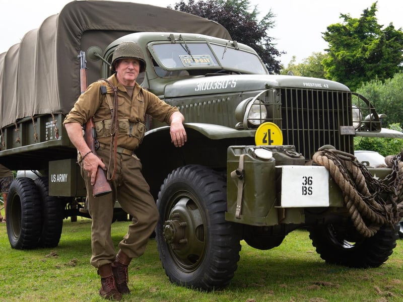 Pictured dressed as an American 2nd Infantry soldier in front of his 1942 Chevrolet G506 is Martin Sharrett