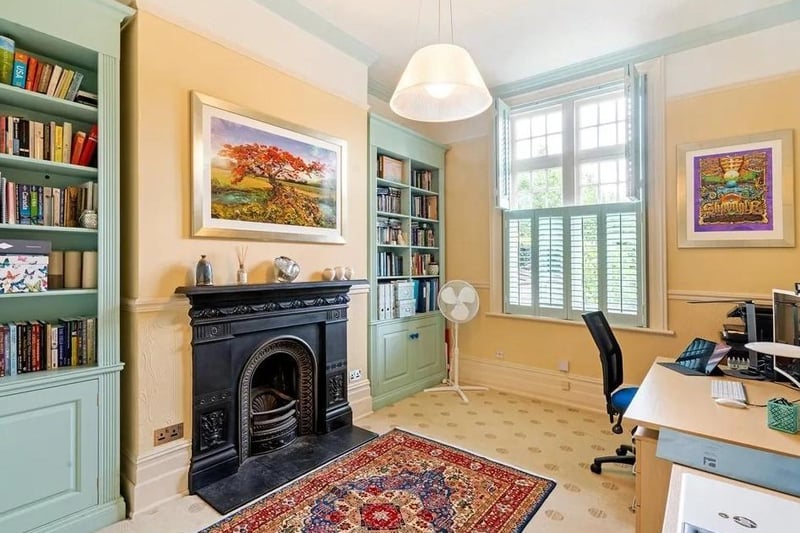The study has shelves fitted into the alcoves either side of its feature cast iron fireplace. Picture: Savills - Haywards Heath.