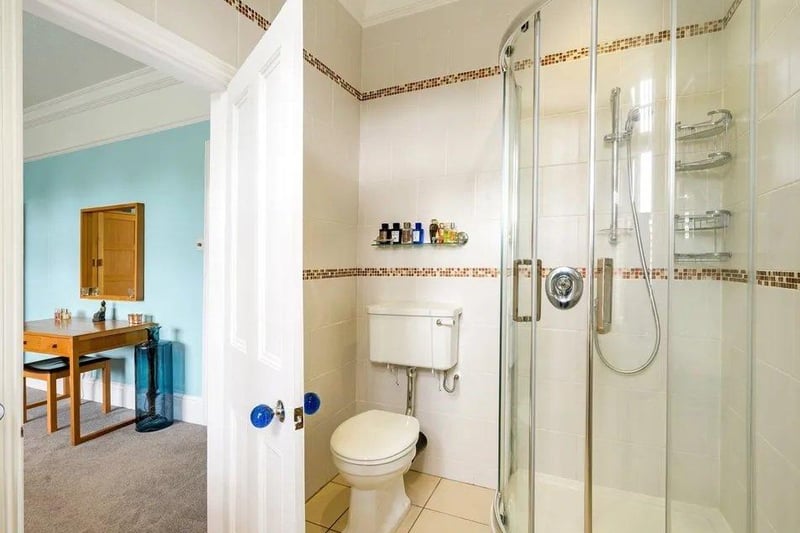 The principal bedroom has a ceiling fan, LED recessed ceiling lights, and an en suite shower room with underfloor heating. Picture: Savills - Haywards Heath.
