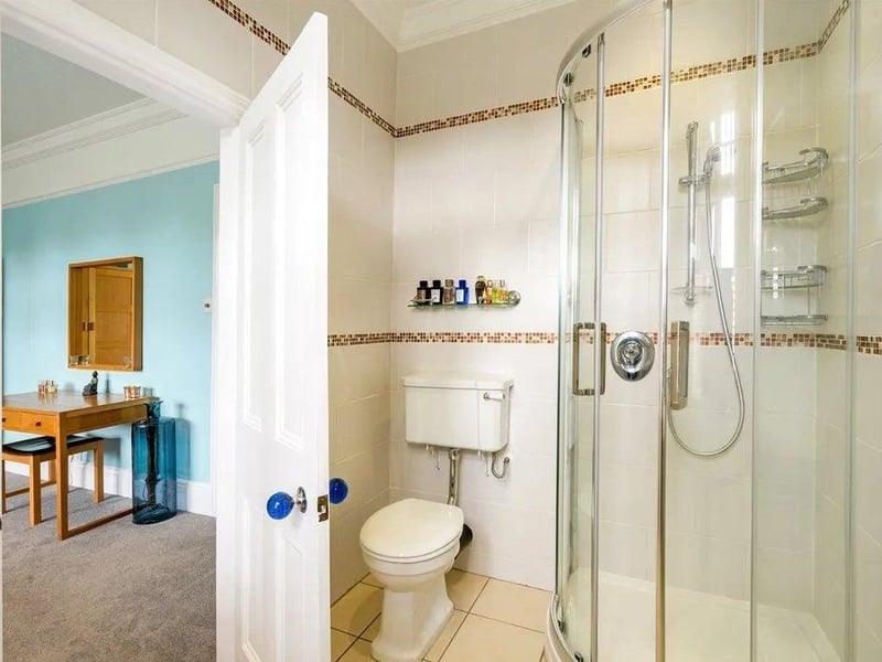 The principal bedroom has a ceiling fan, LED recessed ceiling lights, and an en suite shower room with underfloor heating. Picture: Savills - Haywards Heath.