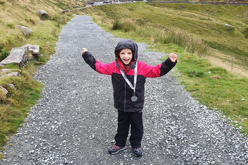 Paige in her climbing gear with her medal after completing the seven hour trek up Mount Snowdon