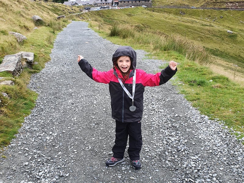 Paige in her climbing gear with her medal after completing the seven hour trek up Mount Snowdon