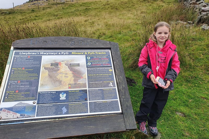 Paige at the information spot about the Miners' and Pyg track up Mount Snowdon