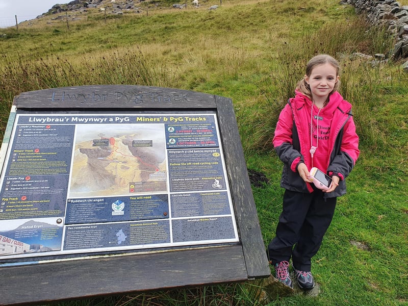 Paige at the information spot about the Miners' and Pyg track up Mount Snowdon