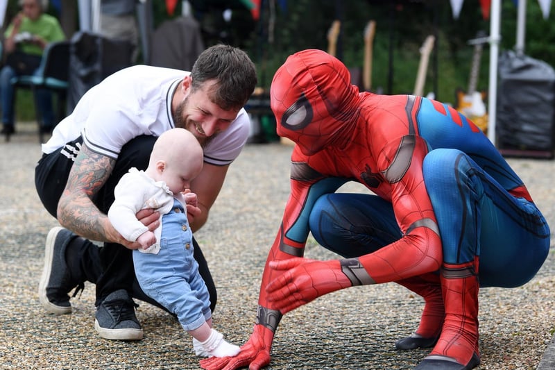 Spiderman meeting one of the younger visitors at the family fun day