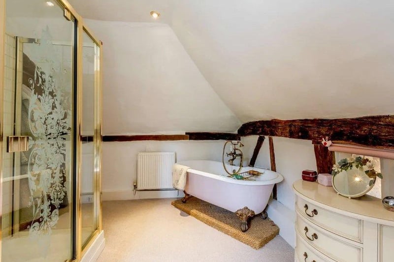 The family bathroom has a feature roll top bath and a separate shower. Picture: Strutt & Parker - Horsham.