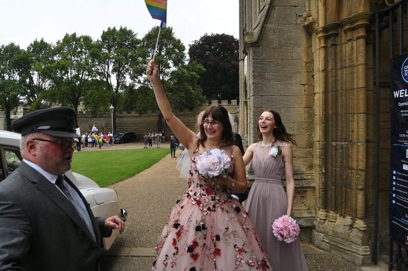 Cassandra Breed enters the cathedral to the sound of cheers and clappping from  Pride marchers before her wedding to husband Daniel: Pictures: David Lowndes