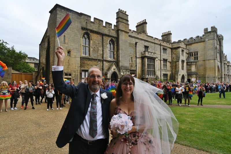 Cassandra Breed with her father Norman Dawson is cheered into the cathedral by Pride marchers before her wedding to husband Daniel: Pictures: David Lowndes