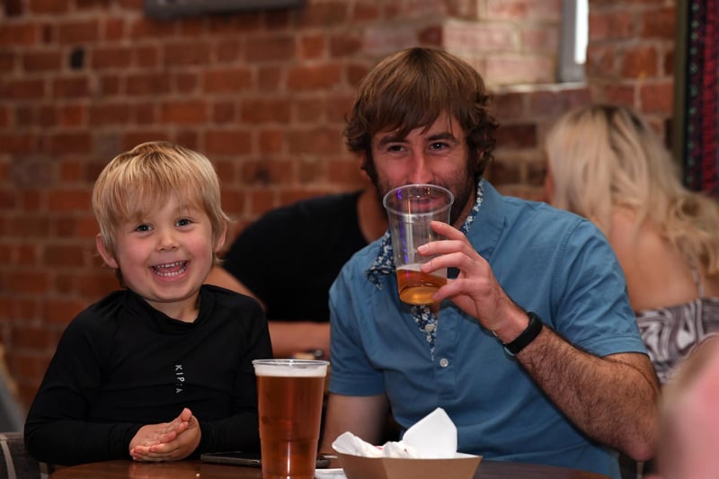 The little man seems happy even if he's too young for to tuck into a cider.
