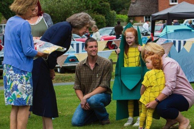The Lord Lieutenant of West Sussex, Susan Pyper, presents first prize in the Revels fancy dress competition, which had a theme of ‘Harvest’, to Maisie and her sister, both dressed as corn on the cob.
