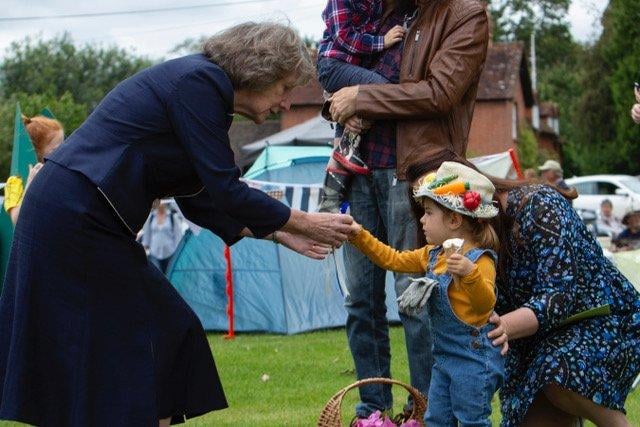 The Lord Lieutenant of West Sussex, Mrs Susan Pyper, presenting a prize to a winner, dressed as a scarecrow, in the fancy dress competition, theme of Harvest, at the Fernhurst Revels