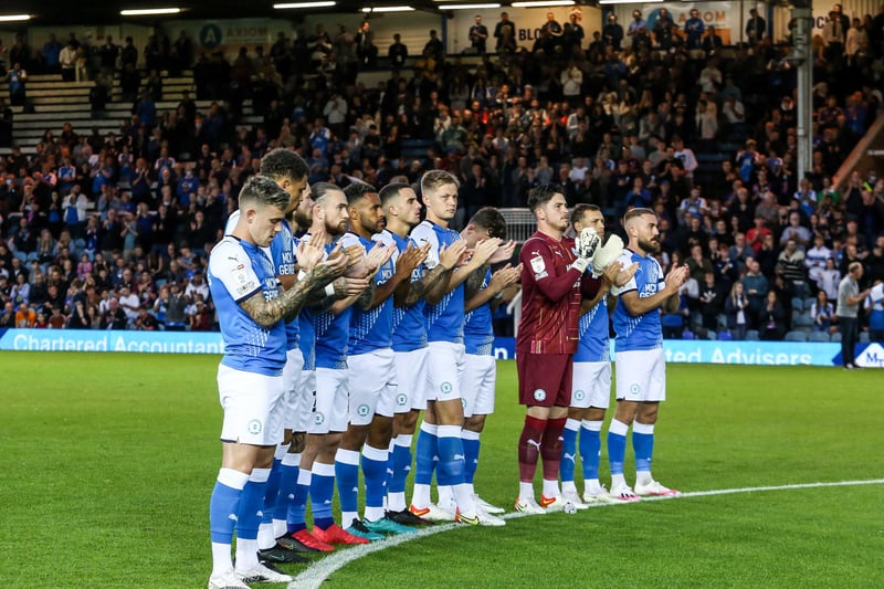 Peterborough United players during a minute's applause ahead of kick-off against West Brom following the deaths of Peter McNamee and Robbie Cooke.