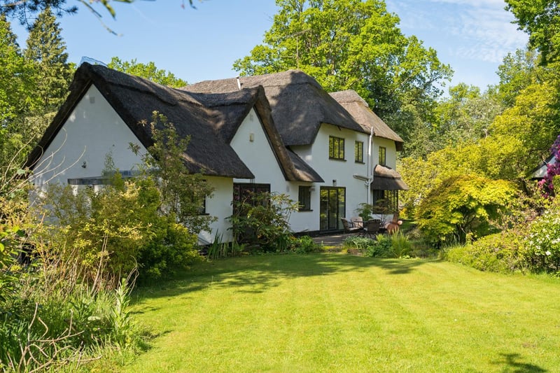 The property has a traditional, thatched roof.