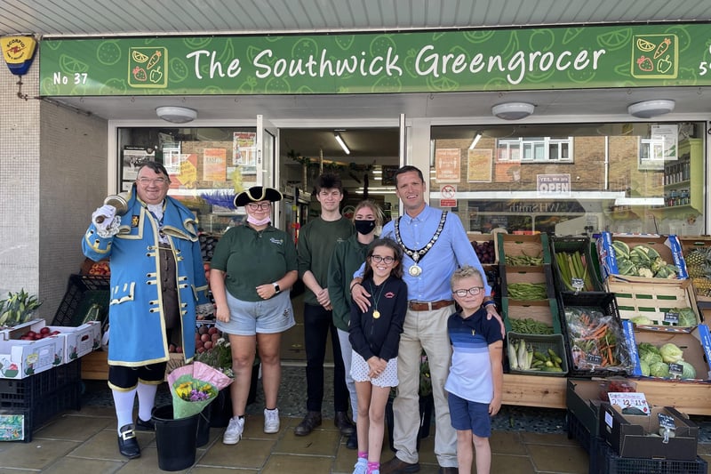 Stephen Chipp, Chairman of Adur District Council, outside The Southwick Greengrocer on Southwick Square, with his children and Bob Smytherman, Worthing town crier