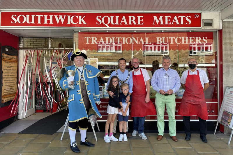 Stephen Chipp, chairman of Adur District Council with his children and Worthing town crier, Bob Smytherman, outside Southwick Square Meets in Southwick