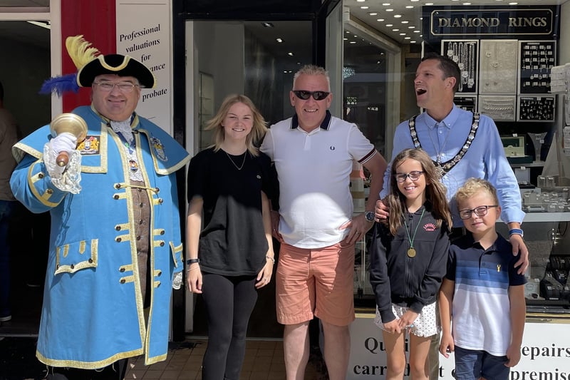 Stephen Chipp, chairman of Adur District Council, outside Coopers Jewellers in Southwick Square, with his children and Worthing Town crier, Bob Smytherman