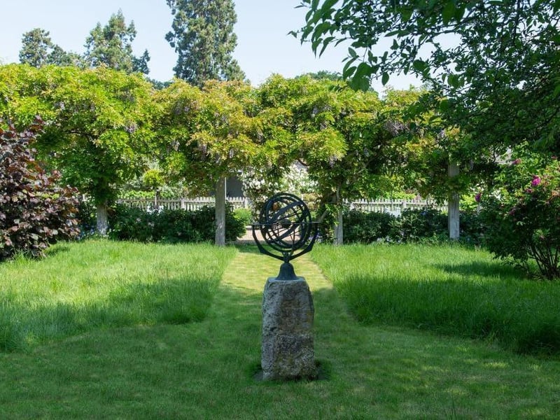 This traditional style home has stunning gardens and overlooks the village church. On the market for 1.5 million.