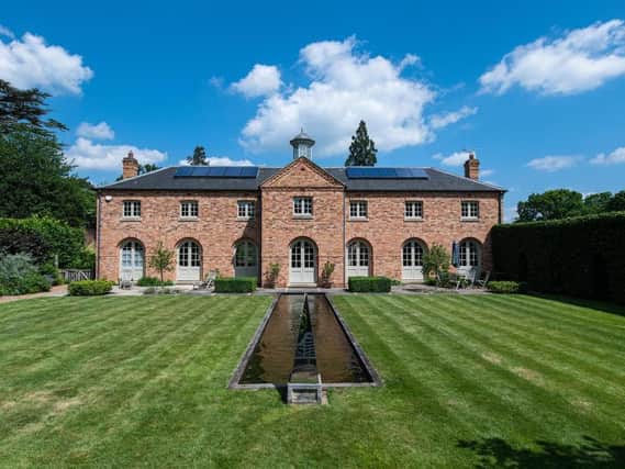 This traditional style home has stunning gardens and overlooks the village church. On the market for 1.5 million.