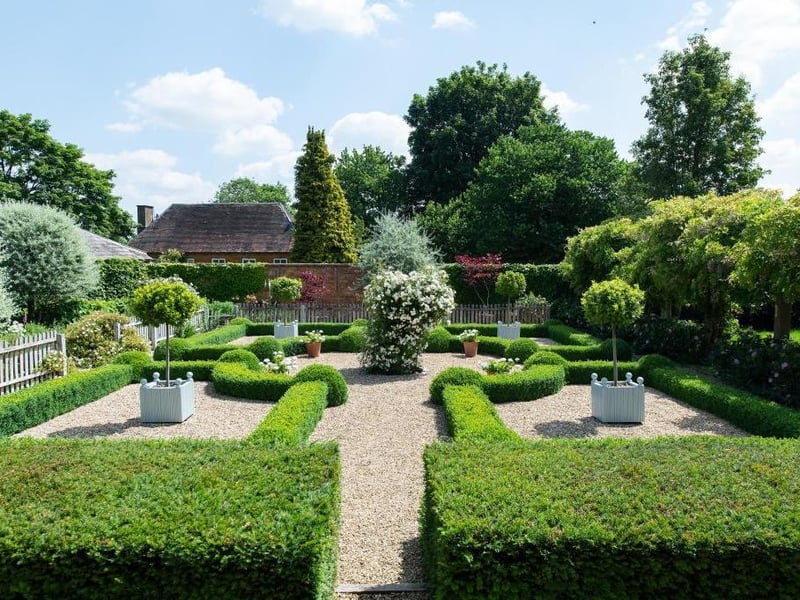 This traditional style home has stunning gardens and overlooks the village church. On the market for 1.5 million.