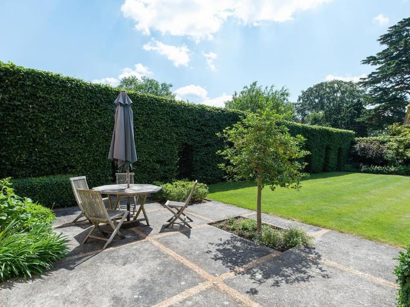 This traditional style home has stunning gardens and overlooks the village church. On the market for 1.5 million.