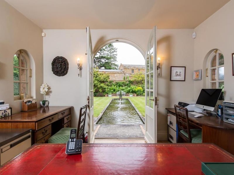 This traditional style home has stunning gardens and overlooks the village church. On the market for 1.5 million.