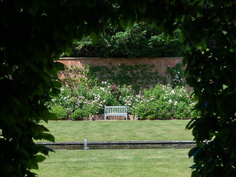 This traditional style home has stunning gardens and overlooks the village church. On the market for 1.5 million.