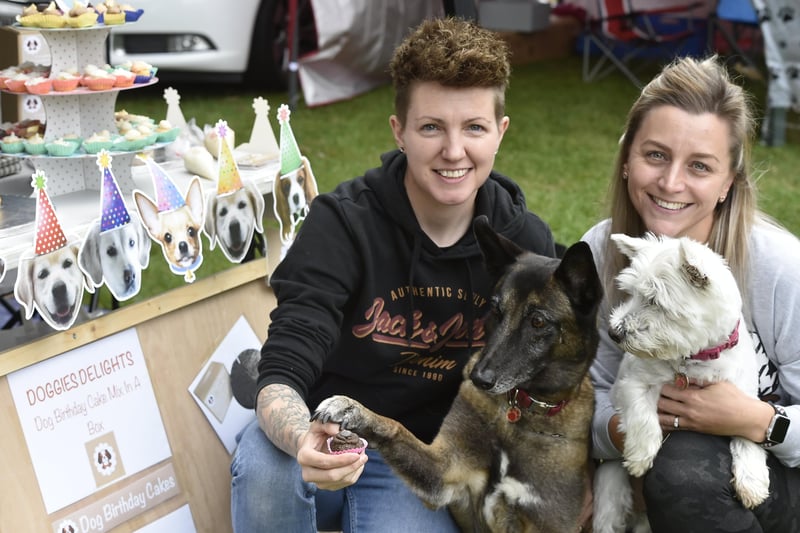 Selling  Doggy's Delight  cakes, Sarah and Stacy Deeley-Carter with their dogs Atya and Dyke