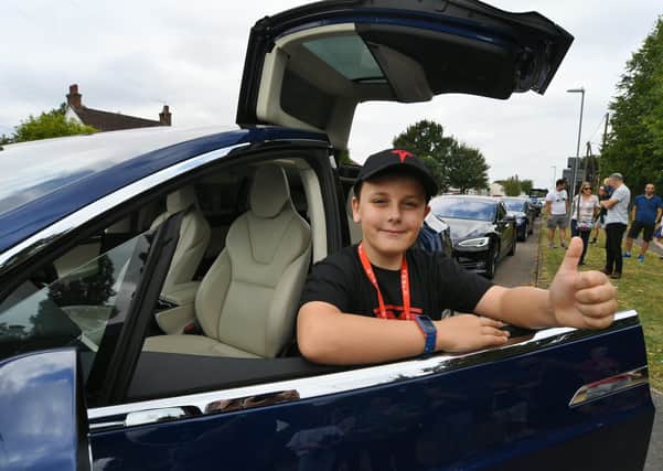Harvey Ahern-Sutliff whose 10th birthday treat was seeing a convoy of Tesla cars at Stilton EMN-210409-201553009