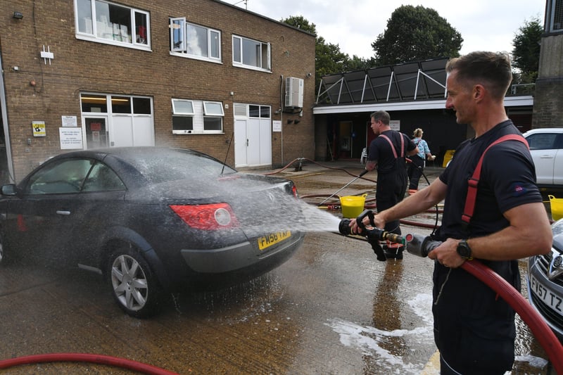 Stanground fire fighters and volunteers at their annual car wash at the Fire Station. EMN-211209-160944009
