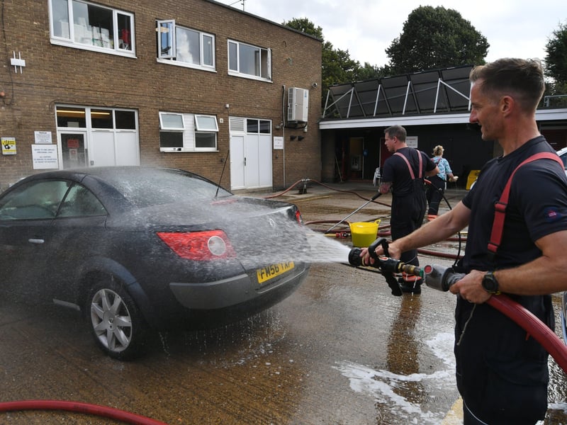 Stanground fire fighters and volunteers at their annual car wash at the Fire Station. EMN-211209-160944009