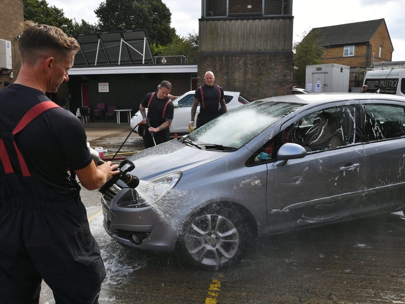 Stanground fire fighters and volunteers at their annual car wash at the Fire Station. EMN-211209-160706009