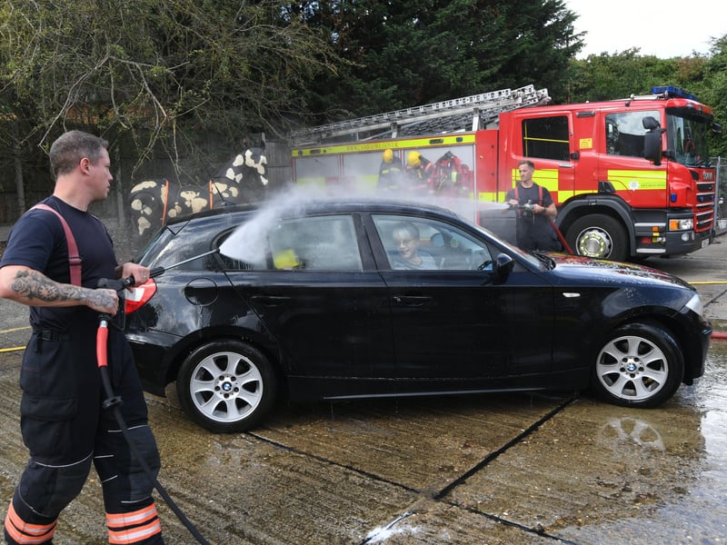 Stanground fire fighters and volunteers at their annual car wash at the Fire Station. EMN-211209-160717009