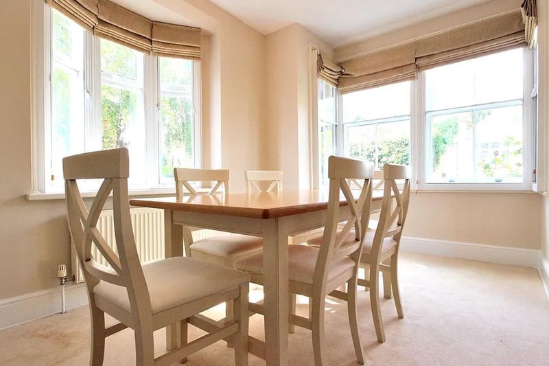 The bright dining room benefits from dual aspect views via two bay windows