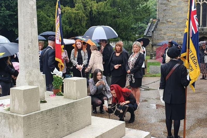Family and friends gather around the Crawley War Memorial