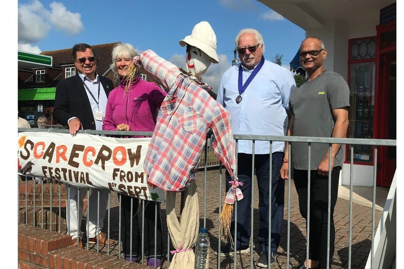 Chairman of Parish, Mike Mendoza, looks delighted to be adjudicating Lancing's scarecrow festival. Let's hope the scarecrows can cheer him up!