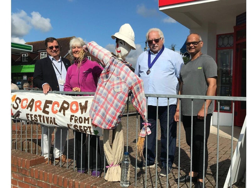 Chairman of Parish, Mike Mendoza, looks delighted to be adjudicating Lancing's scarecrow festival. Let's hope the scarecrows can cheer him up!