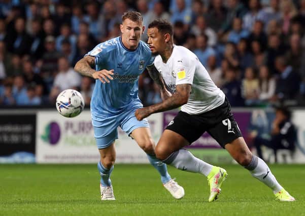 Jonson Clarke-Harris of Peterborough United in action with Kyle McFadzean of Coventry City - Mandatory by-line: Joe Dent/JMP - 24/09/2021 - FOOTBALL - Coventry Building Society Arena - Coventry, England - Coventry City v Peterborough United - Sky Bet Championship EMN-210924-211944005