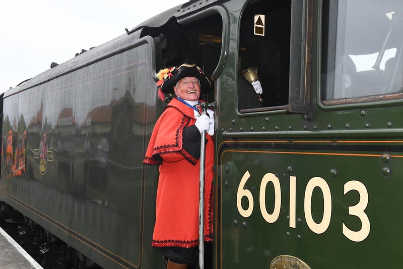 Mablethorpe Town Crier David Summers climbing on board the Flying Scotsman.