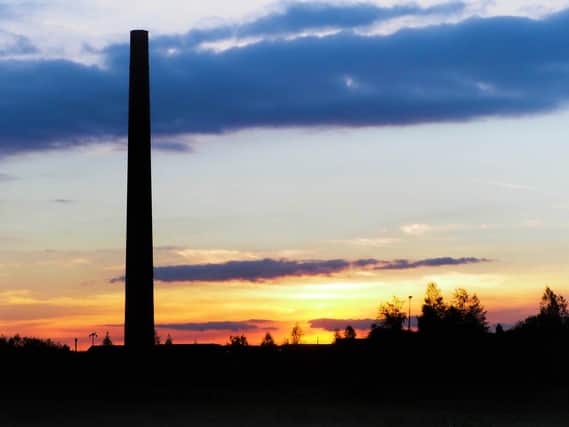 A dramatic sunset view of one of the chimneys