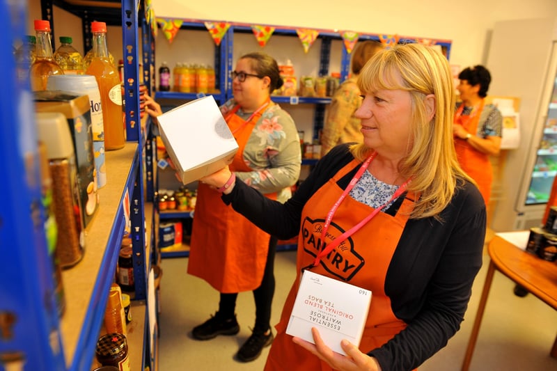 Volunteers put items on the shelves at Burgess Hill Pantry. Picture: Steve Robards, SR2109271.