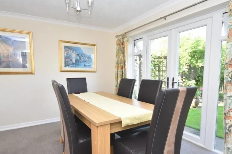 The dining room overlooks the inviting rear garden.