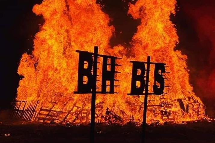 Burgess Hill Bonfire Society's initials silhouetted against the flames.