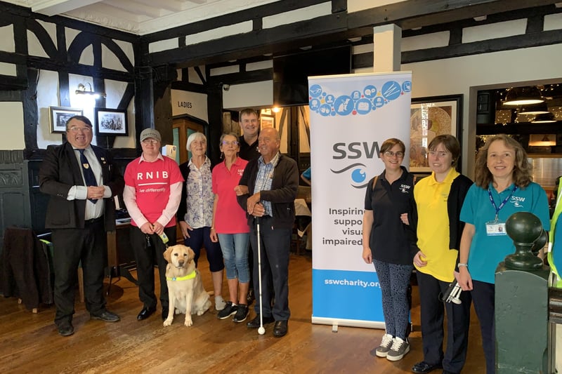 Bob Smytherman, president of Sight Support Worthing, Brian Butcher, trustee of Sight Support Worthing, and other members of the charity at the event at Thieves Kitchen, Worthing