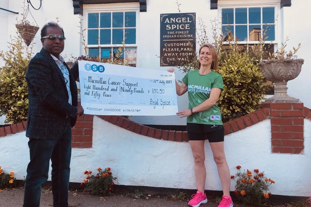 Becky Ford receives a cheque for £890.50 from Abdul Bashir, owner of Angel Spice restaurant in Stilton.
