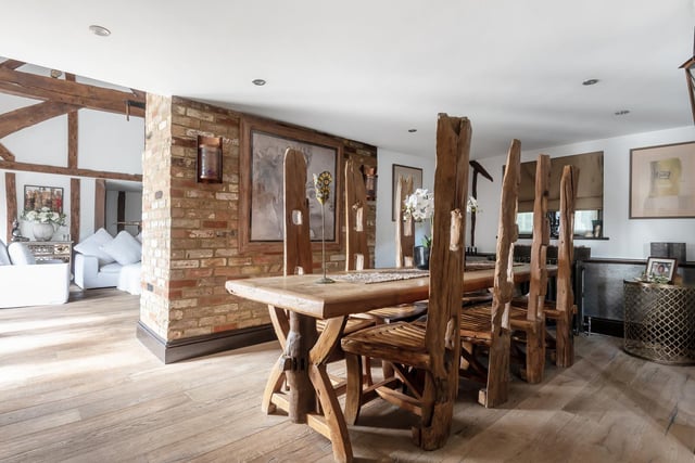 The dining room is a wonderful, light area with a fitted storage cupboard and exposed floorboards.